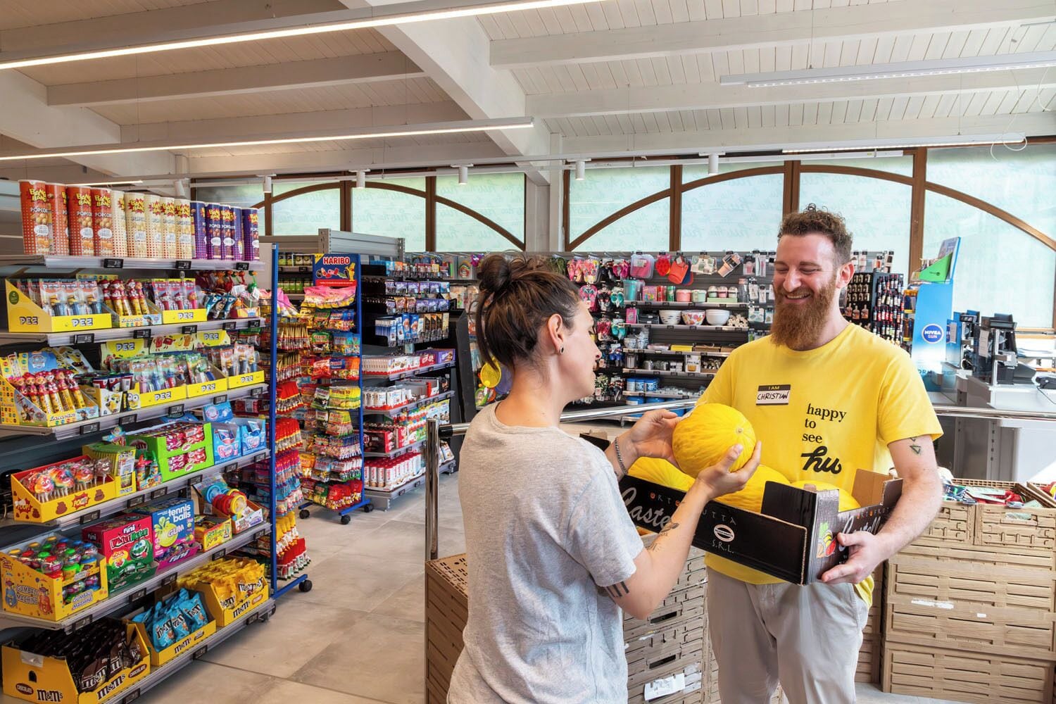 A store interior with shelves stocked with various products, including snacks and household items.