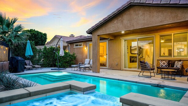 A residential swimming pool with a hot tub, outdoor seating, and a patio area. - Sunset Oasis: GameRoom, Heated Pool, Hot Tub Gate Community (Indio)