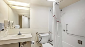 A modern bathroom with a sink, toilet, and shower.