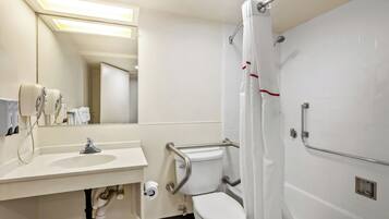 A modern bathroom with a sink, toilet, and shower.