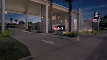 A gas station with a Red Roof Inn sign, a Bonanza Convention Center sign, and a Hometown Studios sign.