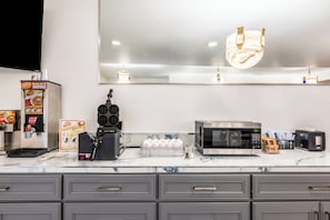 A modern kitchen with a microwave, toaster, and coffee maker. - Red Roof Inn Yuba City Bonanza - Marysville (Yuba City)