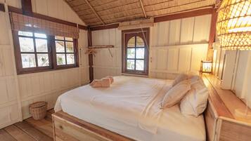 A room with a wooden bed, two windows, a hanging light fixture, and a woven basket.