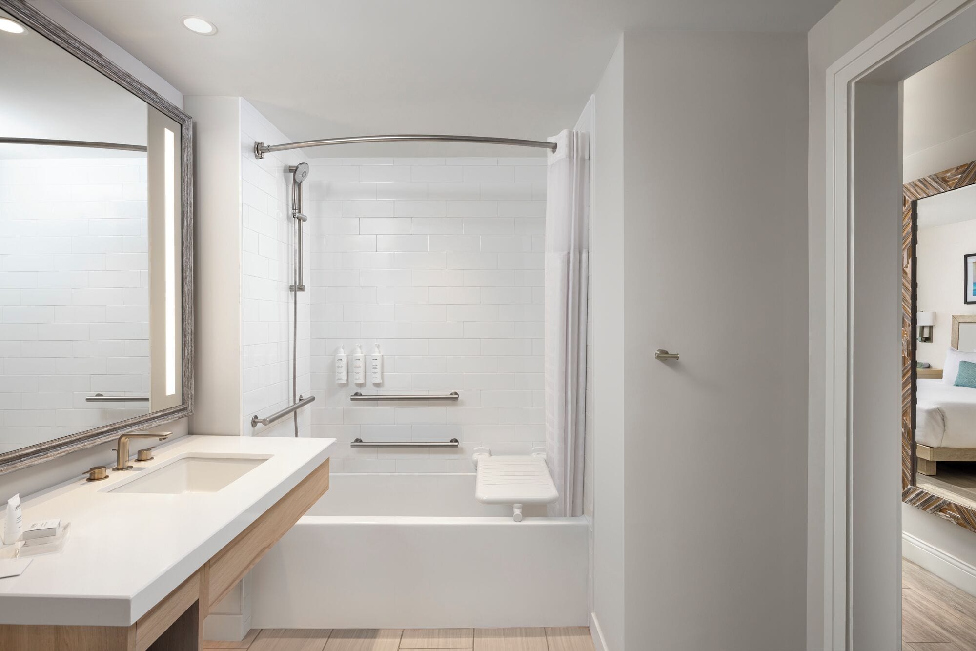 A modern bathroom with a shower, a bathtub, and a vanity with a mirror.