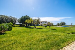 Stroll along the paved pathway through the lush lawn to the main residence.