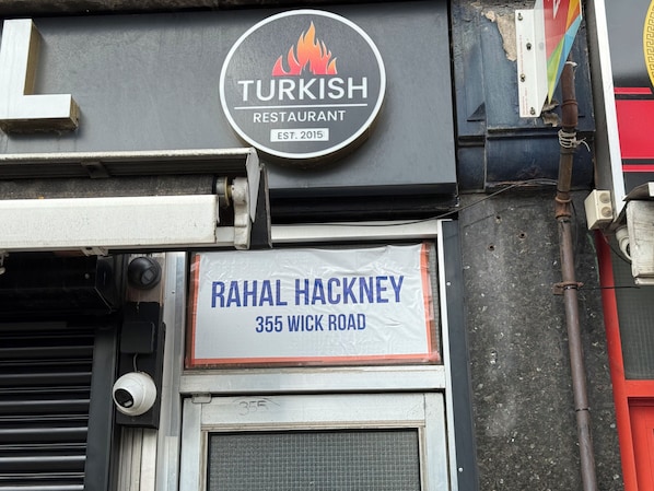 A restaurant sign with the name "Turkish Restaurant" and "Rahal Hackney" address.