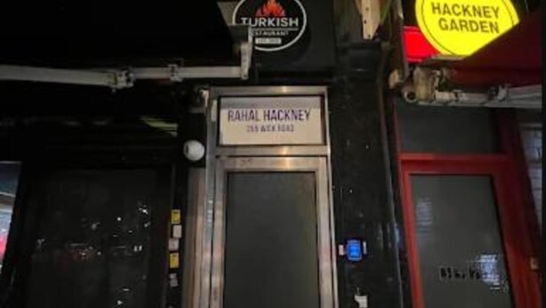 A building with a sign for 'Turkish Restaurant' and 'Hackney Garden'. - Rahal Hotel Hackney London (London)