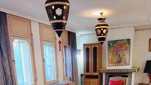 A living room with a sofa, armchairs, a coffee table, and decorative vases. - Villa Avec Piscine Privée au Cœur de la Palmeraie (Marrakech)