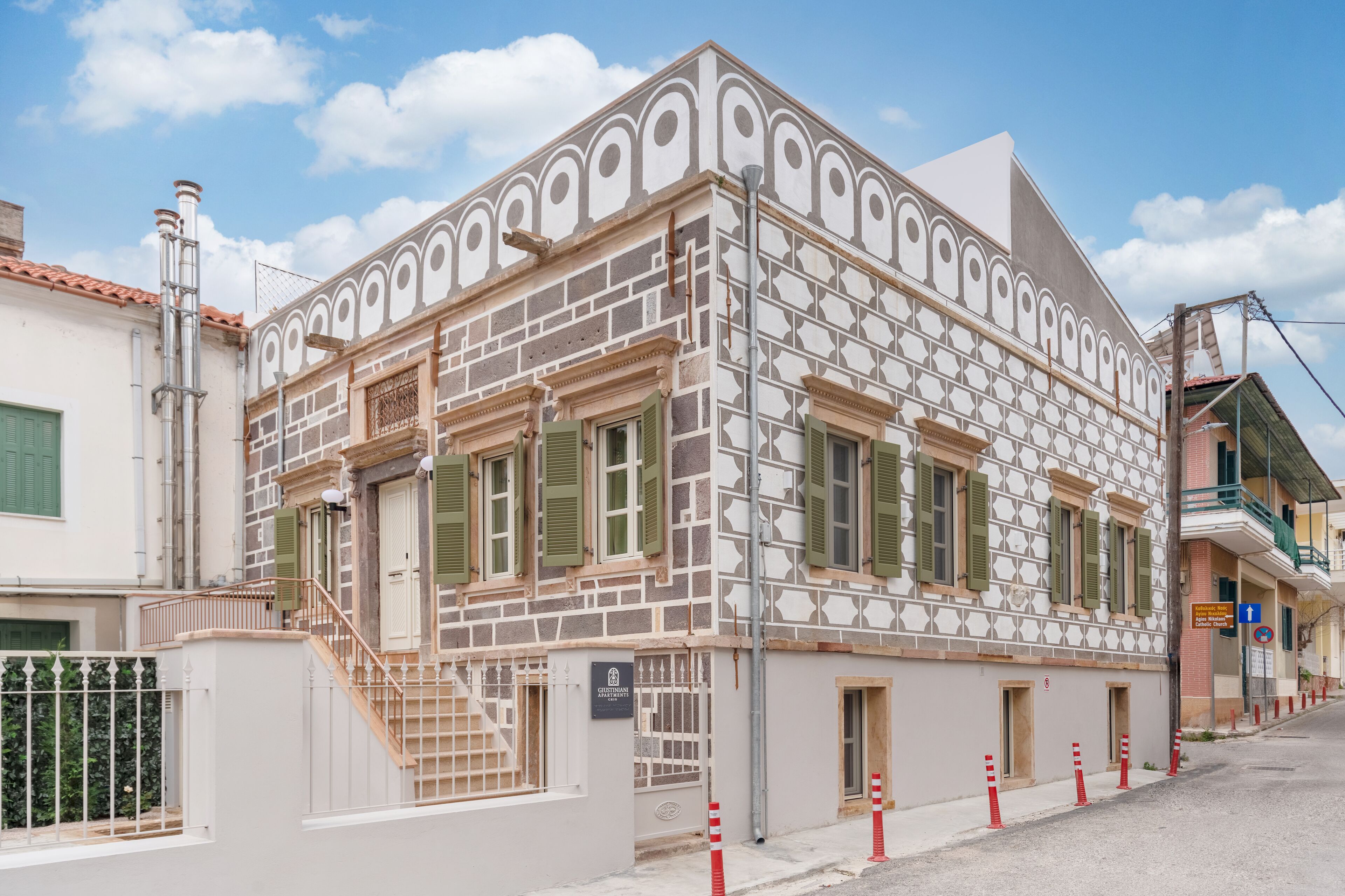 Ein Gebäude mit einer verzierten Fassade, einer Treppe und einem Schild, das ein Restaurant anzeigt.