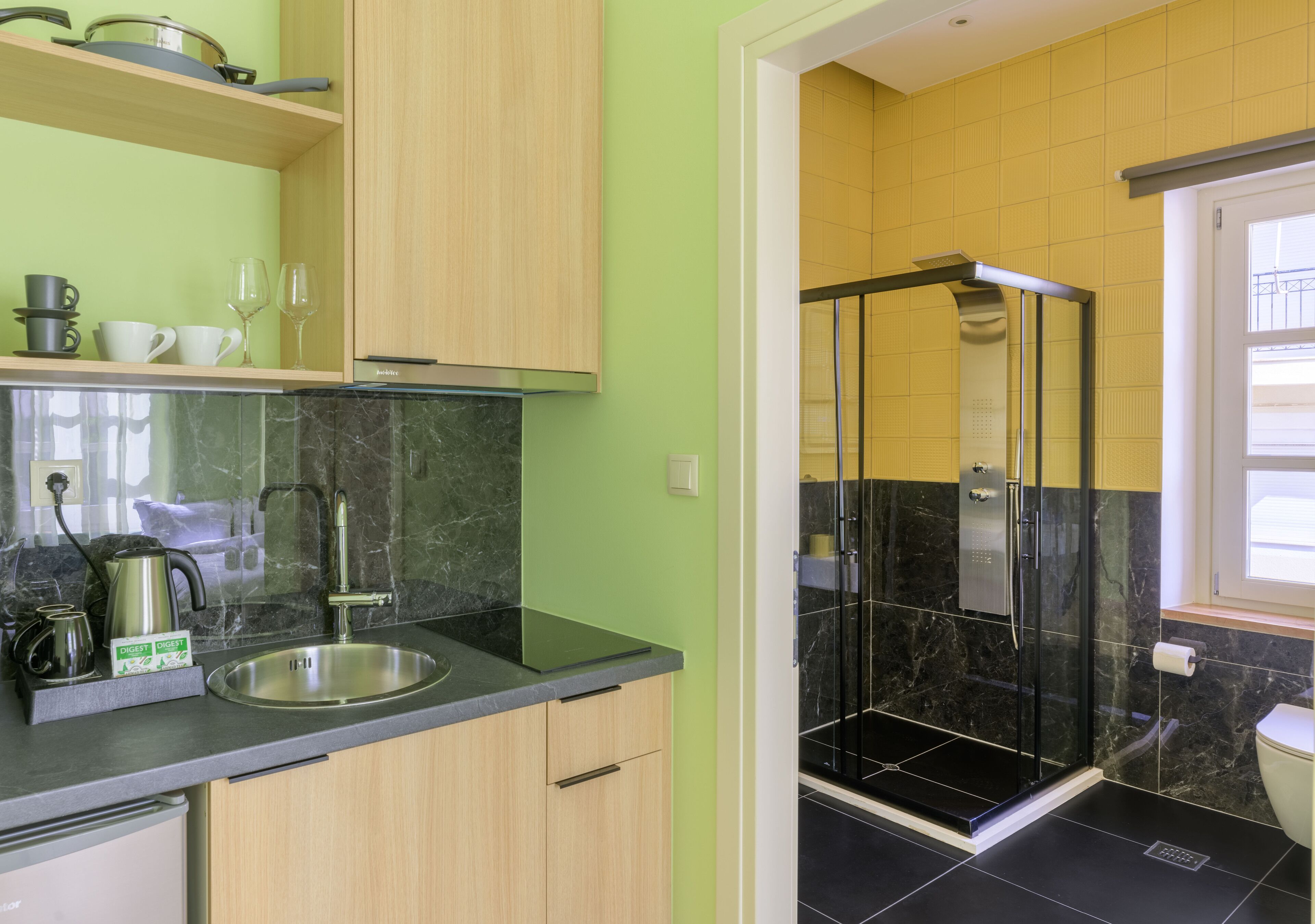 A modern kitchen with a sink, cabinets, and a coffee maker.