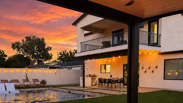 A modern outdoor patio with a fire pit, lounge chairs, and a pool. - Minutes to Old Town · Resort Pool · 3 En Suites (Phoenix)