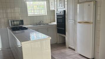 Fridge, microwave, coffee/tea maker, cookware/dishes/utensils