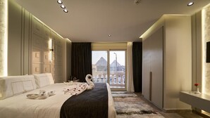 A hotel room with a large bed, a view of a pyramid, and a balcony with a railing. - Pyramids Charm (Giza)