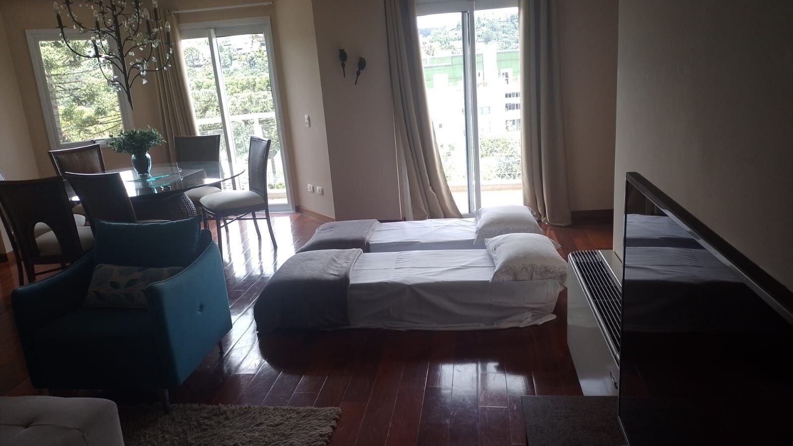 A bedroom with a bed, a desk, and a chair.
