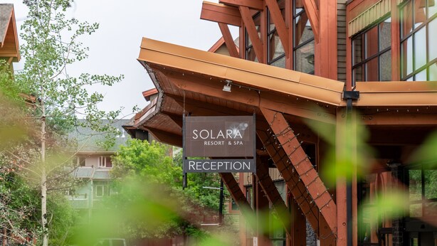 A reception area with a sign for Solara Resort & Spa. - Solara Hotel room with Pool-Hot tub-Gym (Canmore)