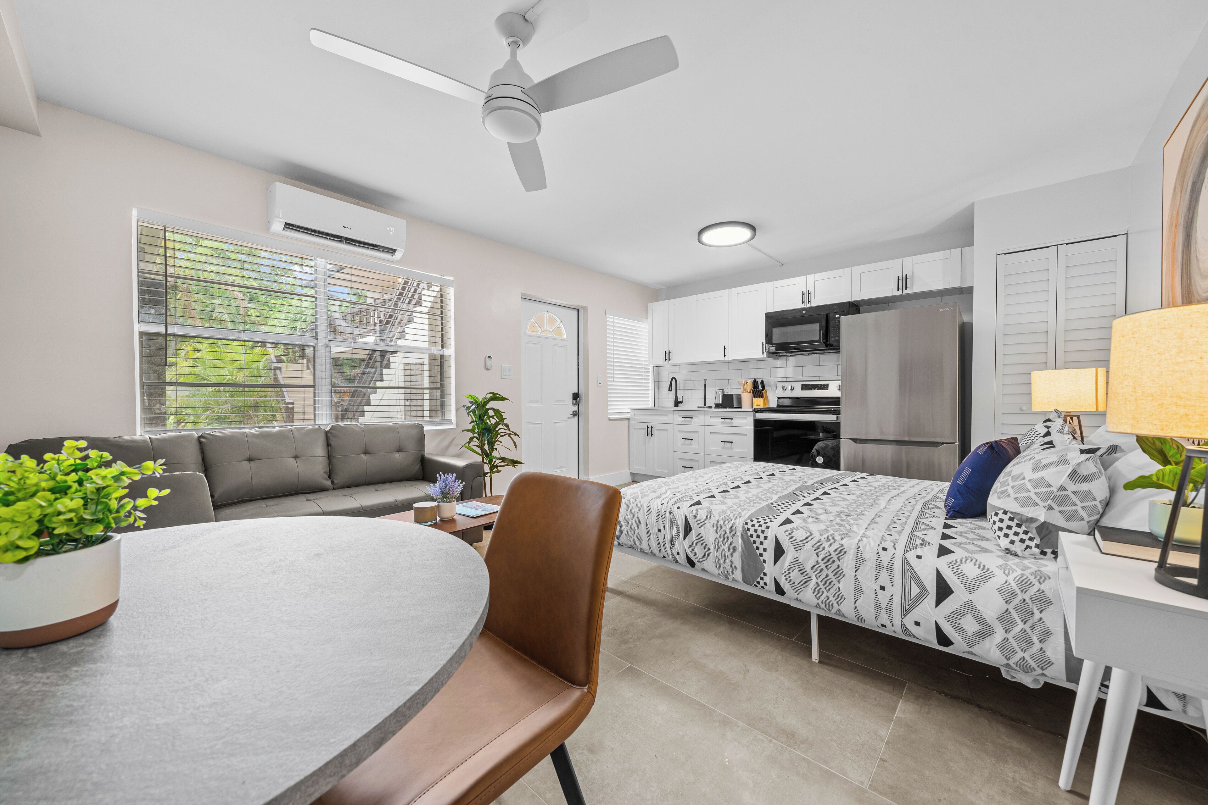 A modern apartment with a kitchen, dining area, and living room.