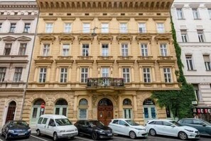 A multi-story building with a classical architectural style, featuring a symmetrical facade with evenly spaced windows and a central entrance.