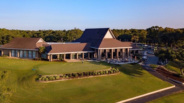A large building with a covered patio area and a golf course in front. - 1st Floor 1BR/1BA Condo w/ Pool: Golf, Swim & Casino nearby! Sunshine Oaks (Diamondhead)