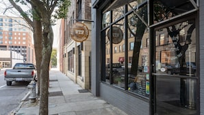 A building with large windows and a tree in front. - Cozy Condo Front Street Wilmington Private Balcony Walking distance  (Wilmington)