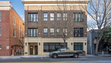 A multi-story building with a brick facade and large windows.