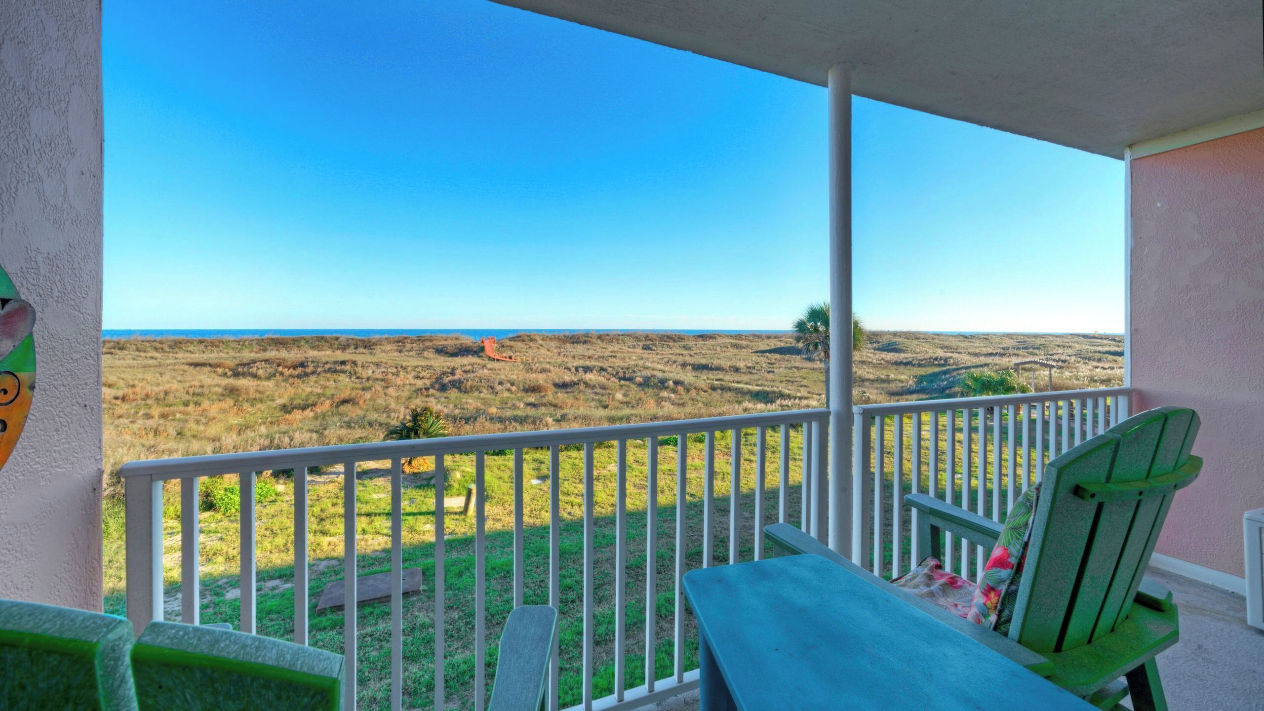 A balcony with a view of a coastal landscape.