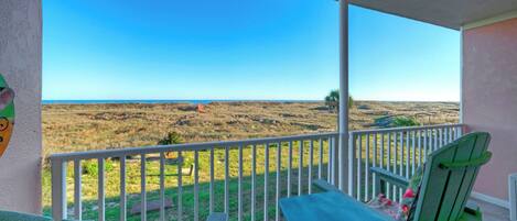 A balcony with a view of a coastal landscape.