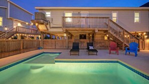 A two-story house with a swimming pool, wooden deck, and outdoor seating area. - Near the Beach w/ Pool, Boat Parking Golf Cart Zone Agave House by Avantstay (Port Aransas)