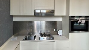 A modern kitchen with stainless steel appliances, a gas stove, a built-in oven, and a sink. - LOFT 17.2 - Verona Journeys (Verona)