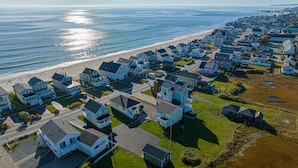 An aerial view of a coastal residential area with houses, a beach, and a road. - Private access to the beach! Sleeps 9. (Wells)