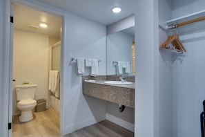 A bathroom with a toilet, sink, mirror, and towel rack. - Motel 6 Selma, CA (Selma)