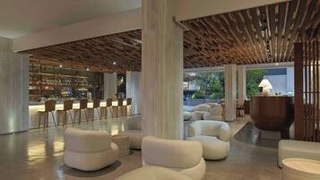 A modern interior with a bar area, seating, and a wooden ceiling design.