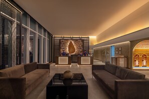 A modern lobby with a reception desk, sofas, and a decorative wall. - Sofia Colombo City Hotel (Colombo)