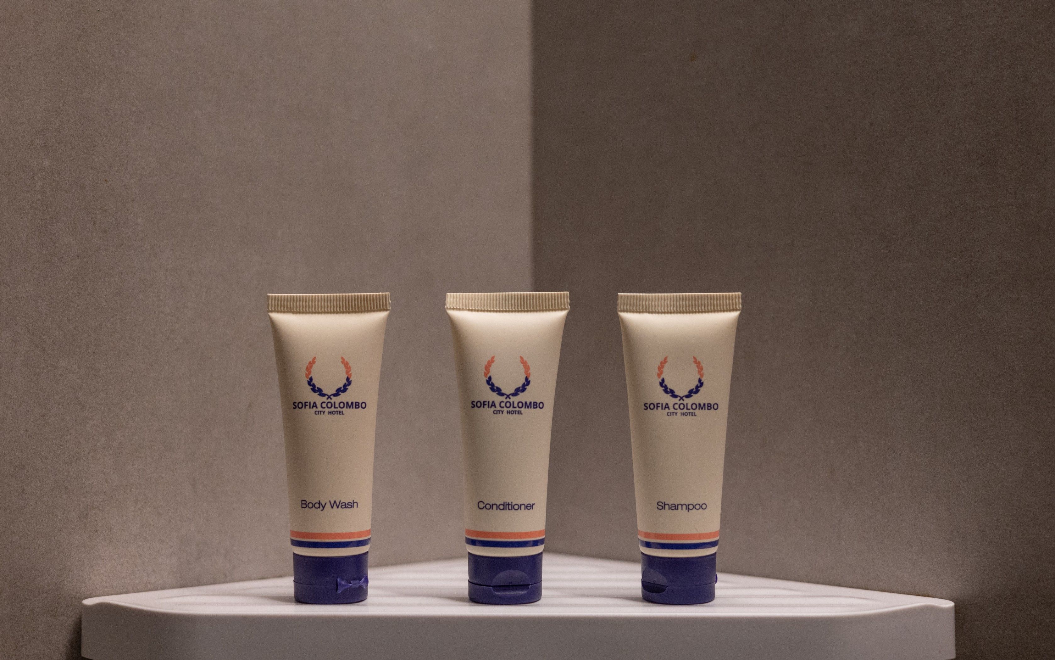 Three toiletries on a white surface against a plain background.