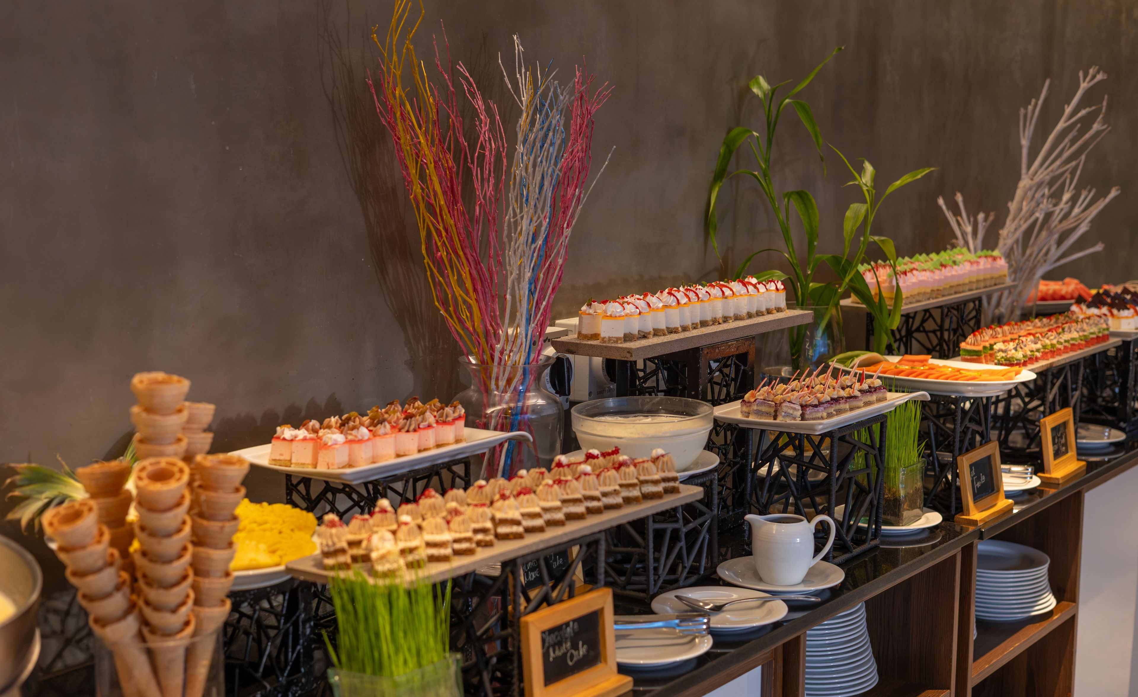A buffet with various desserts and a coffee station.