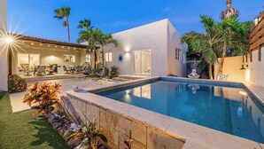 A pool with a clear blue water surface, surrounded by a stone deck and palm trees. - 3BR 2BA Near Eagle Beach w/ Private Pool (Noord)