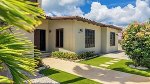 A modern house with a tiled roof, a well-maintained lawn, and a clear sky. - 3BR 2BA Near Eagle Beach w/ Private Pool (Noord)
