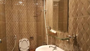 A bathroom with a toilet, sink, and shower. - New Paris Hotel - by Bay Luxury (Ho Chi Minh City)