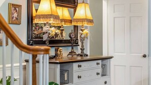 A staircase with a white railing, a white door, and a wooden handrail. - Beland Mansion Getaway – Spacious Colonial with Game Room & Lounge (Fort Smith)