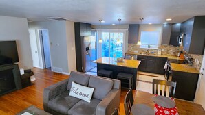 A modern apartment with a living room, kitchen, and dining area.
