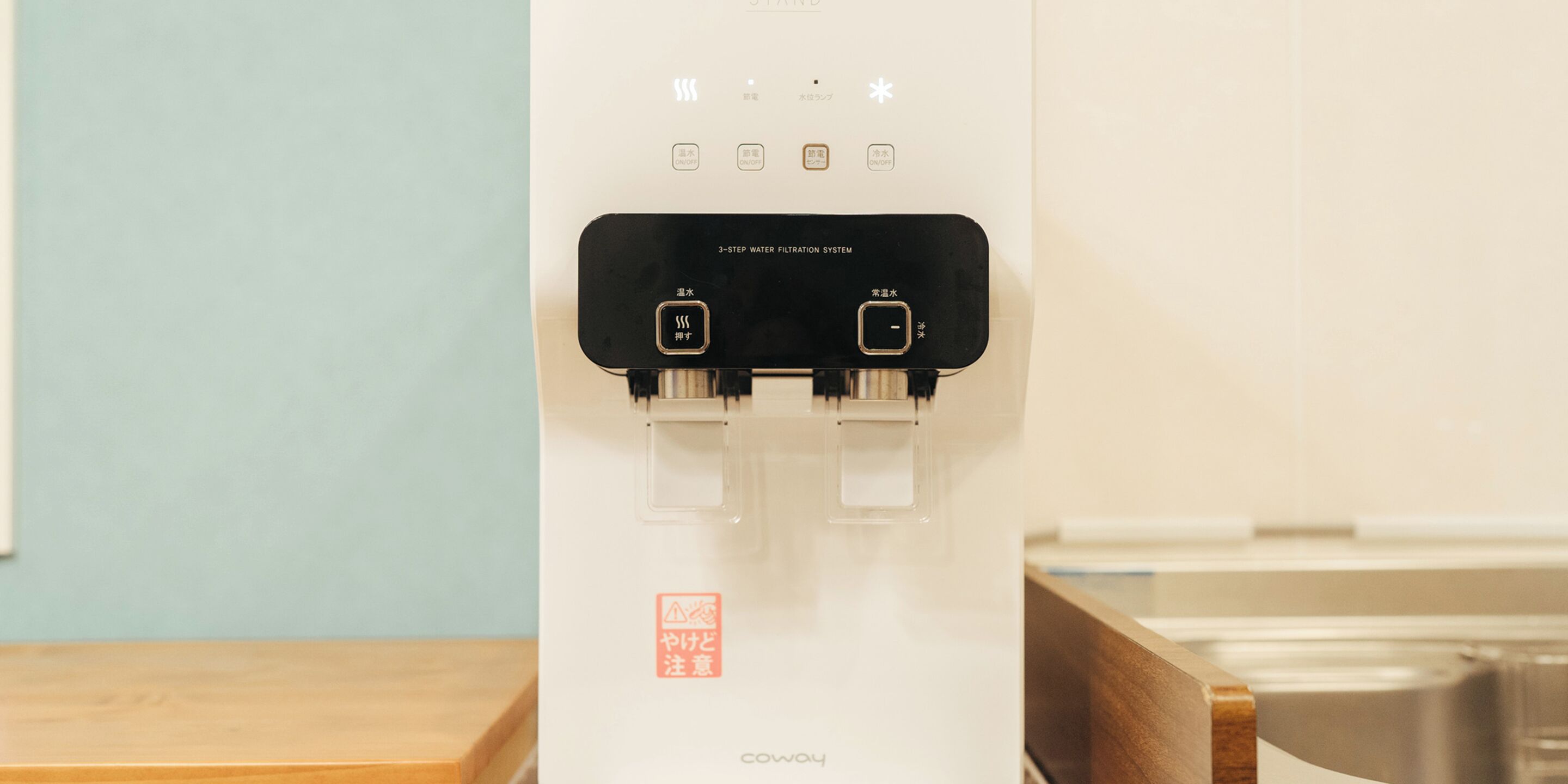A water filtration system with two taps and a control panel.