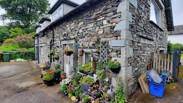 A stone cottage with a sign reading "FAIRFIELD COTTAGE".
