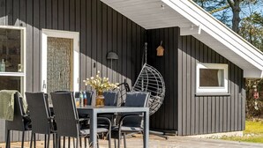A modern outdoor dining area with a table, chairs, and potted plants. - "Akka" - 2km from the sea by Interhome (Saltum)