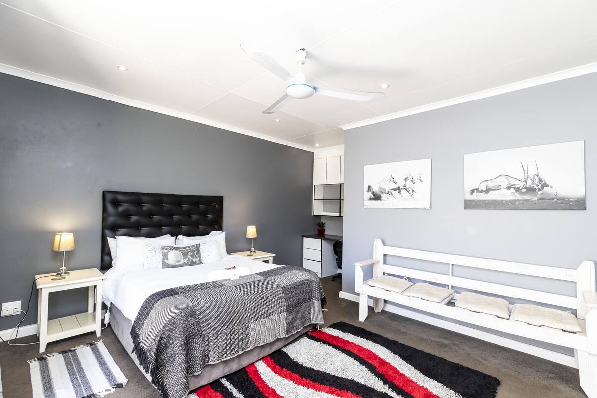 Premium bedding, desk, laptop workspace, iron/ironing board
