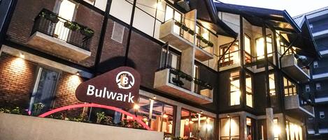 A hotel with a modern architectural design, featuring multiple balconies and a prominent 'Bulwark' sign.