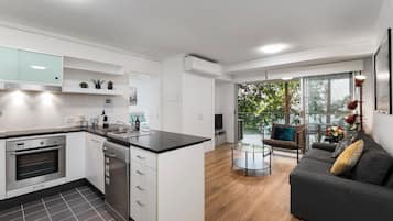 Economy Apartment, 2 Bedrooms | Living area | 50-inch flat-screen TV with cable channels