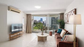 Two-Bedroom Apartment with Balcony and Two Bathrooms | Living area | 50-inch flat-screen TV with cable channels