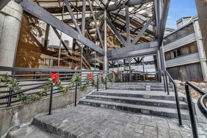 Ein Gebäude mit Metallkonstruktion, Treppen zu einer oberen Ebene und Geländern mit roten Verzierungen.