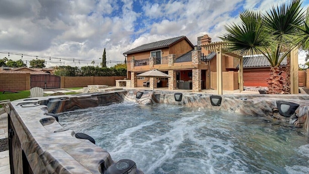 A house with a hot tub, outdoor seating, and a large palm tree. - Scottsdale Kierland Compound (Scottsdale)