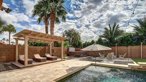 A backyard with a swimming pool, outdoor seating, a pergola, and a barbecue area. - Scottsdale Kierland Compound (Scottsdale)