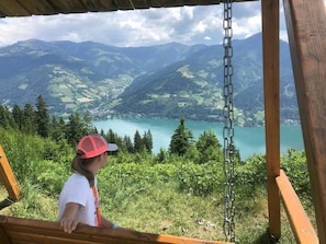 A person overlooking a lake with mountains in the background.